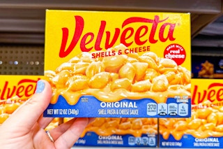 hand holding a box of velveeta shells and cheese