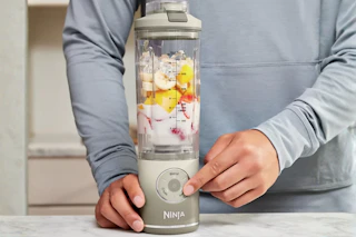 a man using a ninja portable blender
