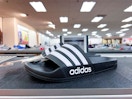Adidas shoes on top of shelf in store