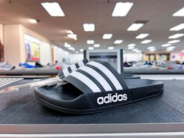 Adidas shoes on top of shelf in store