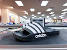 Adidas shoes on top of shelf in store