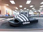 Adidas shoes on top of shelf in store