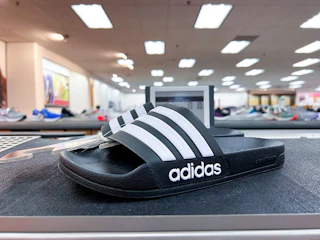 Adidas shoes on top of shelf in store