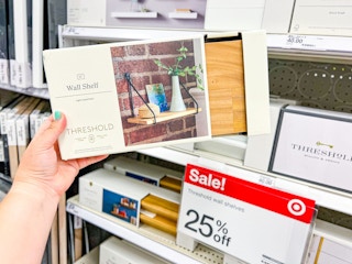 Threshold floating shelves at Target with a Sale sign in the background for 25% off