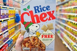 hand holding a box of general mills chex cereal