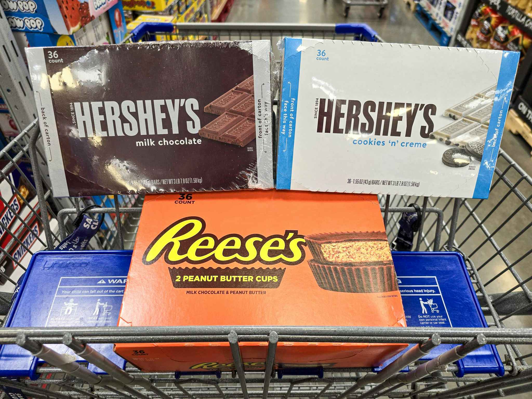 boxes of hersheys and reeses candy bars in a cart