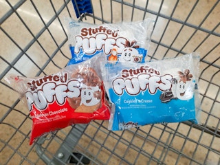 Three packages of Stuffed Puffs marshmallows in Walmart shopping cart