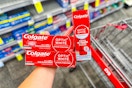 hand holding colgate optic white toothpastes in cvs
