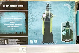 box containing a 5-foot fortune witch on a shelf