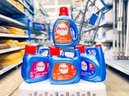 four bottles of persil detergent on laundry basket in walmart aisle