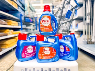 four bottles of persil detergent on laundry basket in walmart aisle