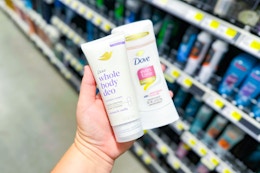 hand holding dove deodorants