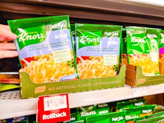 hand holding a pack of knorr sides on walmart shelf