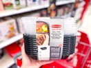 hand holding a rubbermaid meal prep set in front of a target cart