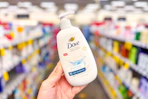 hand holding a bottle of dove hand soap