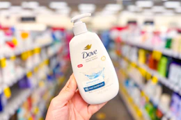 hand holding a bottle of dove hand soap