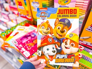 hand holding a coloring book in walmart aisle