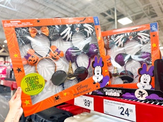 person grabbing a 5-pack of disney halloween headbands
