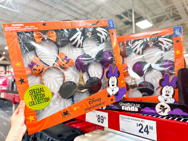 person grabbing a 5-pack of disney halloween headbands