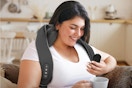 a woman using a neck massager