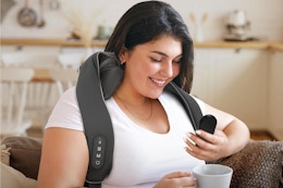 a woman using a neck massager