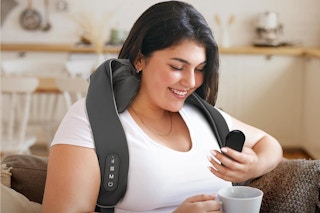 a woman using a neck massager