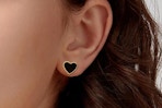 heart shaped earrings being worn