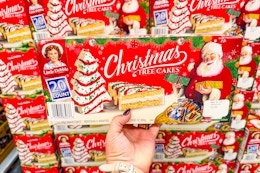 hand holding a box of little debbie christmas tree cakes