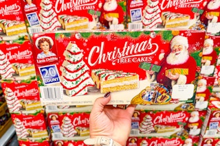 hand holding a box of little debbie christmas tree cakes