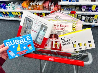hand holding bubble skincare gift set with others in a shopping cart