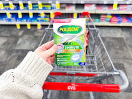 hand holding a box of polident tablets