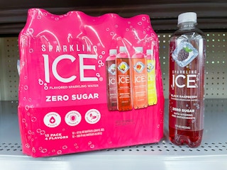 A variety pack of Sparkling Ice sitting next to a single Sparkling Ice Black Raspberry on a store shelf.