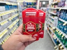 hand holding two old spice deodorants in walgreens