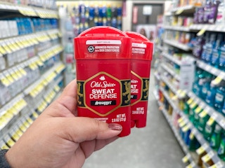 hand holding two old spice deodorants in walgreens