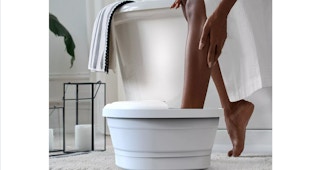 a women using a bubble bath foot massager