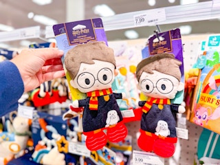 hand holding a harry potter baby teether blanket in front of a target shelf