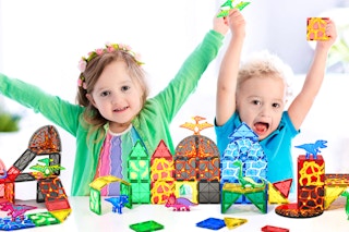 kids playing with the Dinosaur Magnetic Tiles Set