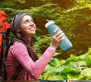 a woman outside with a water bottle