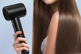 a person holding a hair dryer