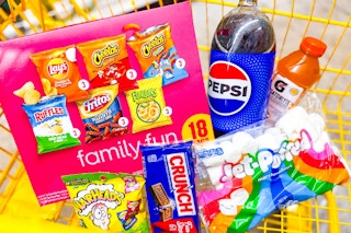 dollar general frito lay, pepsi, crunch, warheads, jet puffed, gatorlyte in a shopping cart