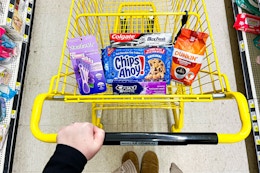 chips ahoy, skintimate, colgate, dunkin in a yellow shopping cart