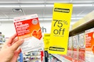 someone holding up a CVSHealth product next to a clearance sign at CVS