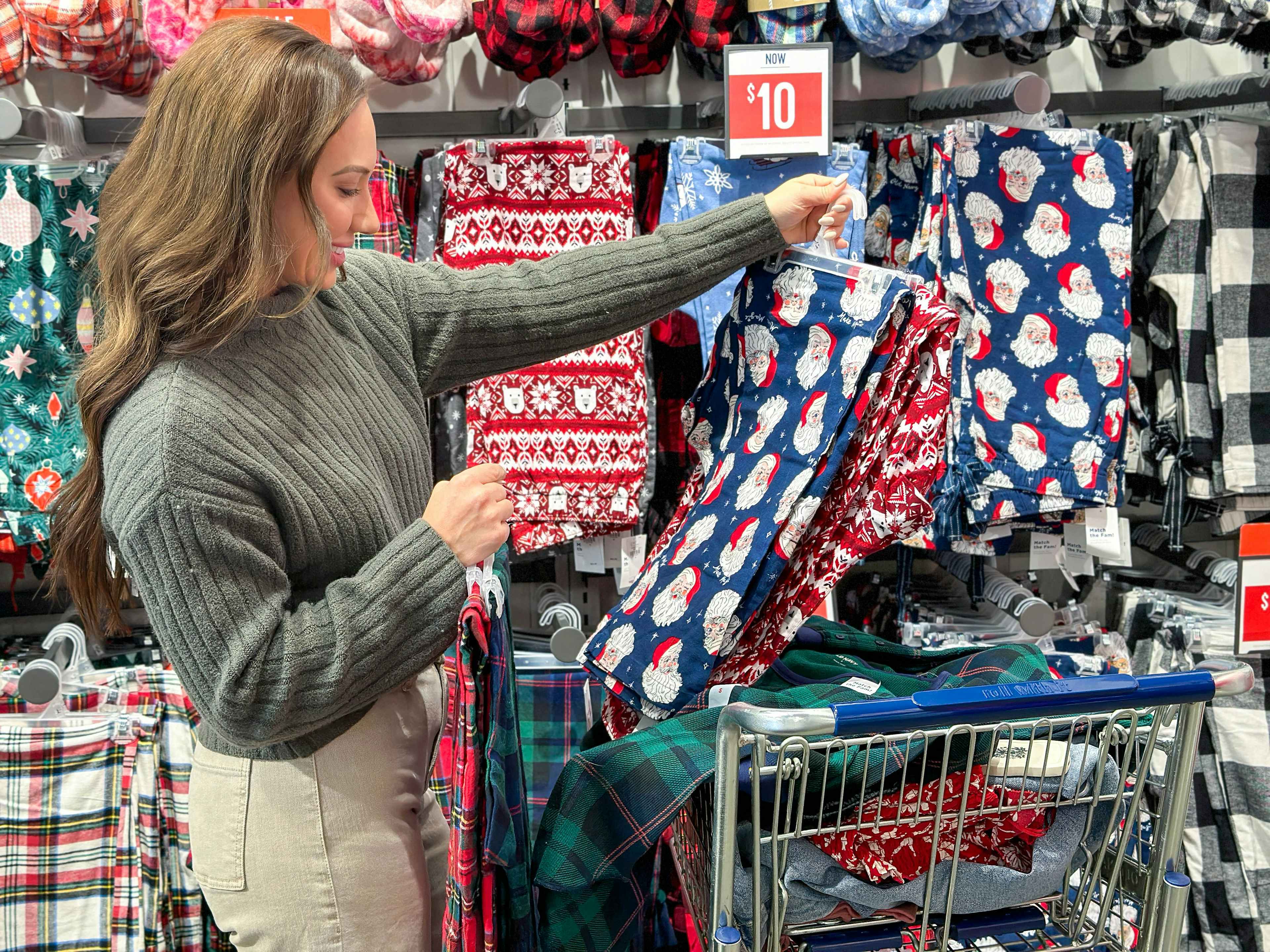 a woman looking at christmas pjs in store 