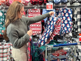 a woman looking at christmas pjs in store 