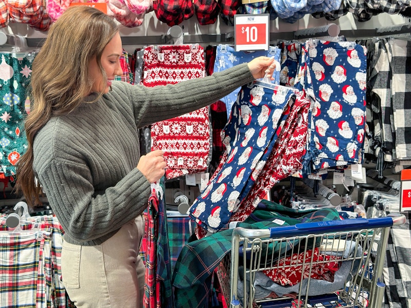 a woman looking at christmas pjs in store 