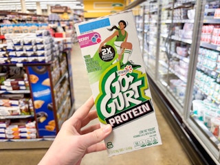 hand holding a box of yoplait gogurt protein tubes