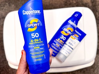 hand holding coppertone sport sunscreen