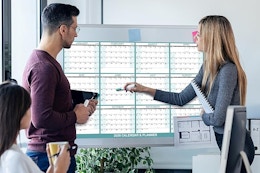 a group looking at a magnetic calendar