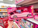 hand grabbing a hot wheels barbie rc corvette off a target shelf