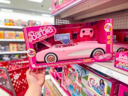 hand grabbing a hot wheels barbie rc corvette off a target shelf